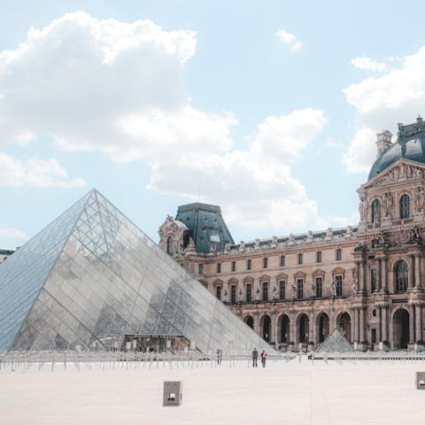 Explore the art collections at the Louvre Museum, a short walk away