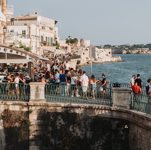 Cross the bridge between Isola di Ortigia and Syracuse