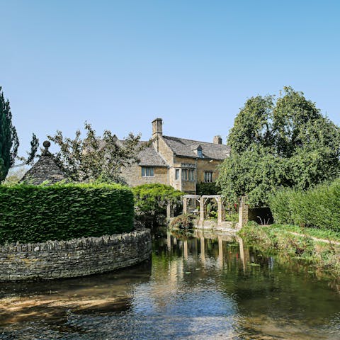 Enjoy a leisurely stroll around Bourton-on-the-Water, a fifteen-minute drive away