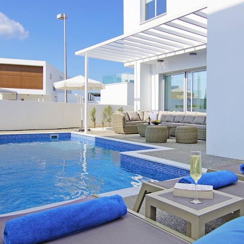 Spend endless sunny days luxuriating by the azure pool
