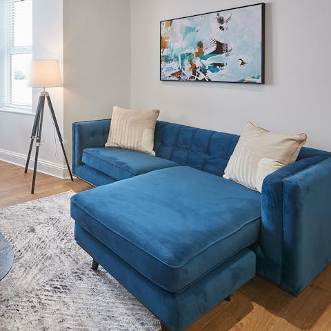 Relax on the comfy blue velvet sofa after a day on the beach