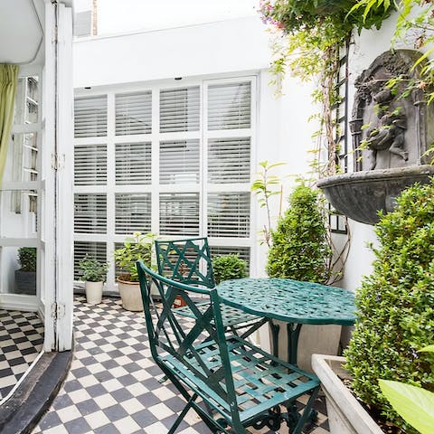 Watch the sky change colour while sat out in the home's leafy terrace