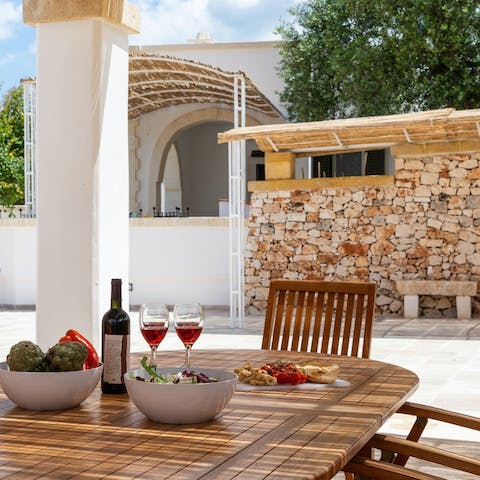 Sit out on the shaded terrace and clink wine glasses under the sun
