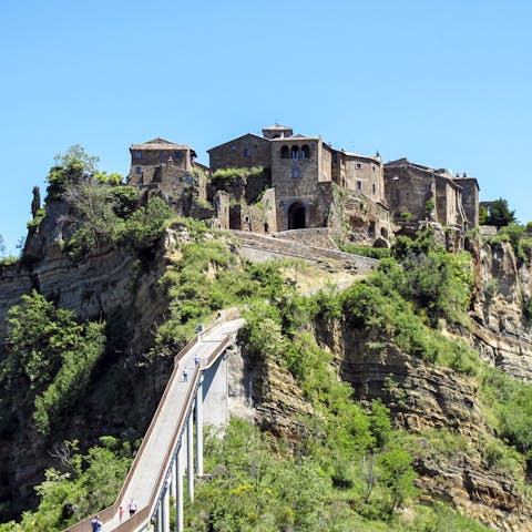 Visit the charming hilltop village of Civita di Bagnoregio, a thirty-minute drive away