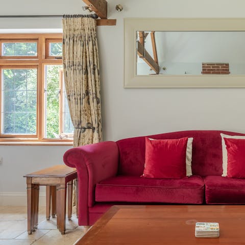 Get cosy in front of the wood-burner on the plush pink sofas, a glass of wine in hand