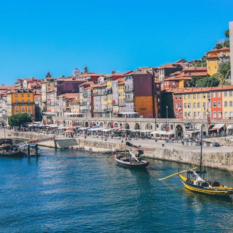 Explore bustling Cais da Ribeira along the Douro River, thirty-five minutes away by Metro