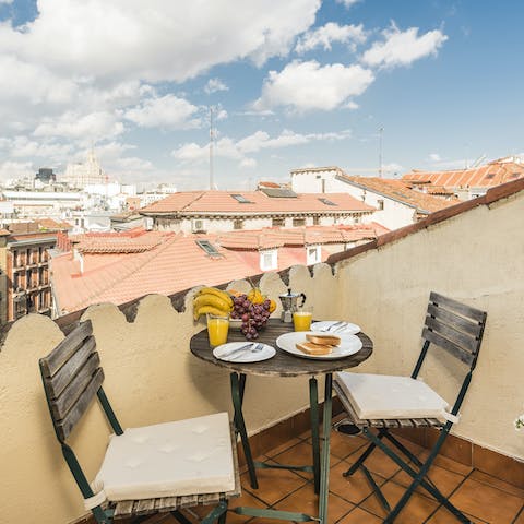 Enjoy a sunny breakfast on the private balcony while feasting on rooftop views over the city