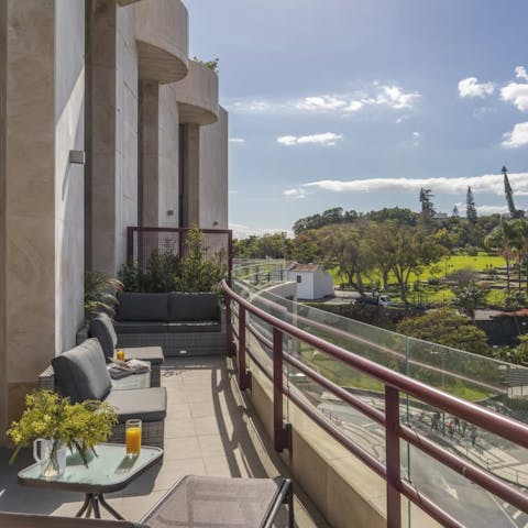 Sip a morning coffee on your private balcony with green views before you