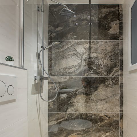 Jump in the shower and wash off the city, sea, and sand under the rainfall shower head