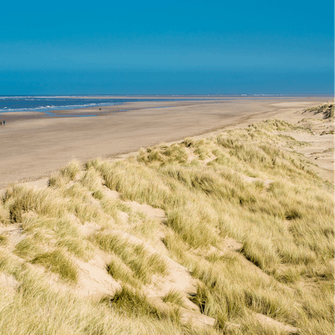 Spend leisurely days on the sandy beaches of North Norfolk's coast, a twenty-five-minute drive away