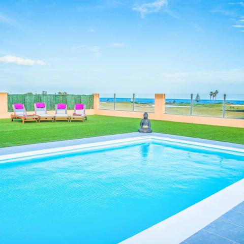 Splash about in your private heated pool and admire the sea views