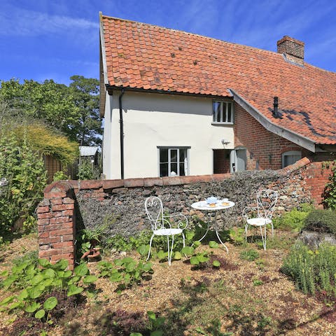 Soak up the morning sun surrounded by wild flowers, a cup of tea in hand