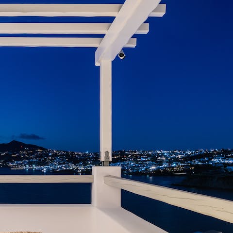 Enjoy the bright lights of Mykonos by night