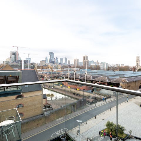 Take in views over Tobacco Dock and London's city skyline from the private balcony