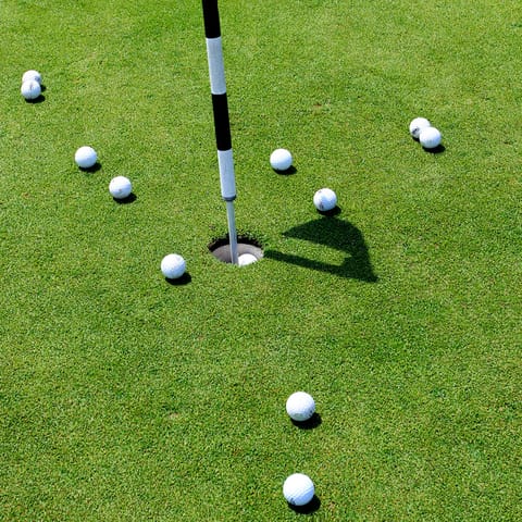 Swing and putt the golf ball, while nestled between the hills and sea