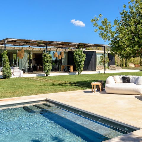 Dream away by the crystalline pool on the outdoor sofas