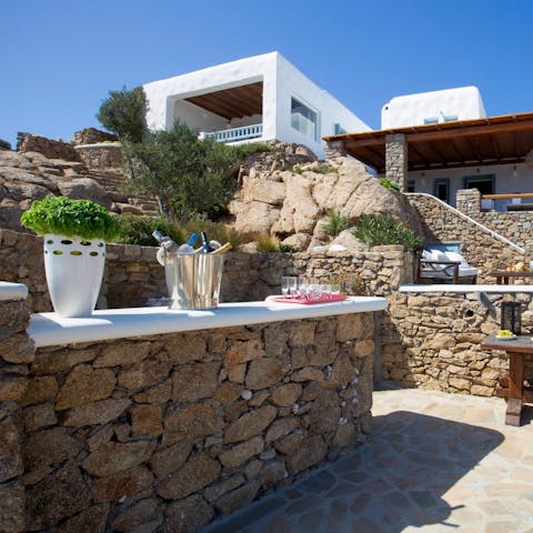 Shake things up with a refreshing ouzo cocktail at the outdoor bar