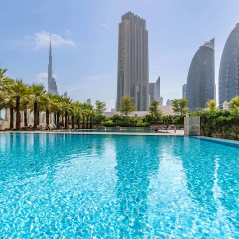 Relax by the glittering pool, surrounded by skyscrapers and palm trees, taking dips to cool off
