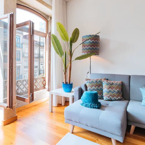 Relax in the bright living space, with the balcony doors thrown open