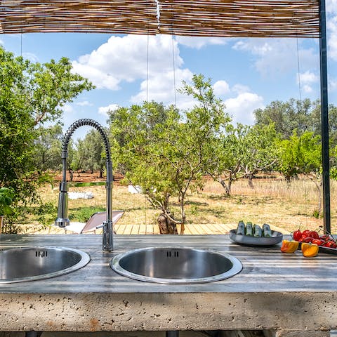 Prep orecchiette and fresh veg with a view of the olive grove from the outdoor kitchen