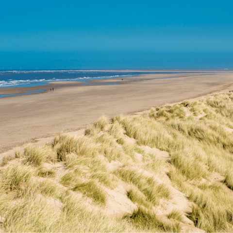 Wander the long sandy stretch of Brancaster Beach, just 10 minutes away