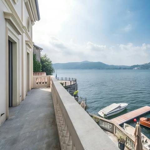 Sip a coffee on the balcony as day breaks over Lake Como