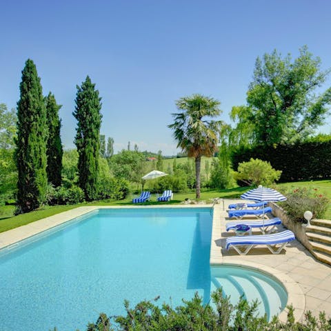 Relax by the dreamy outdoor pool with a glass of French wine in hand