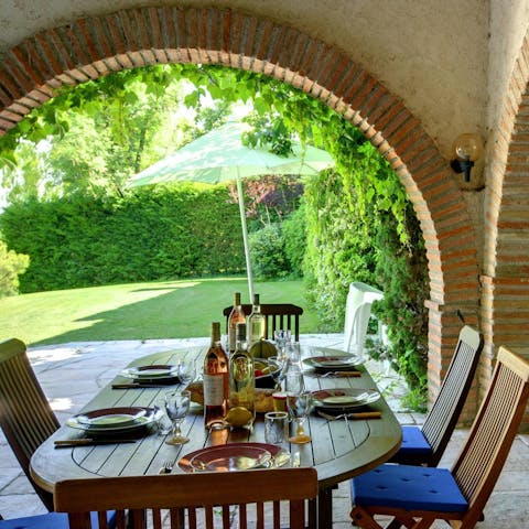 Gather around the alfresco dining table situated on the covered terrace