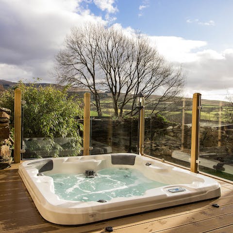 Watch the day pass by from the bubbles of your private hot tub