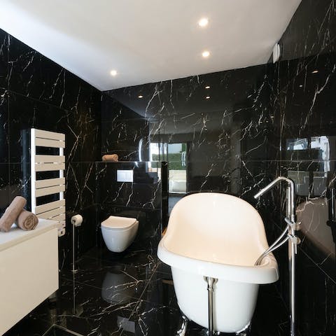 Luxuriate in the main bedroom's marble en-suite