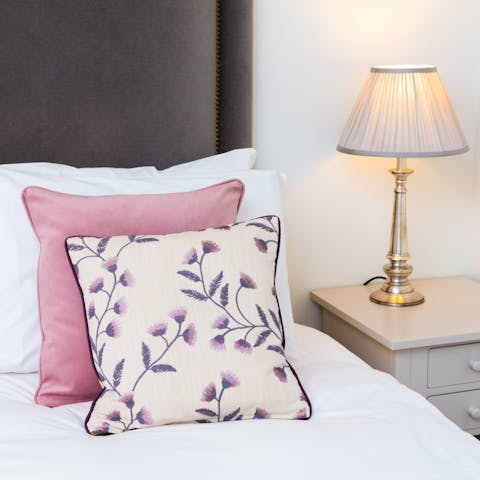 Sink into the sumptuously made bed