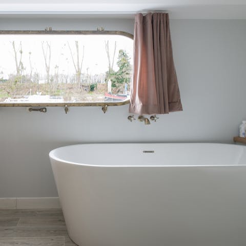 Soak in the freestanding tub with its river vistas after a busy day in Paris