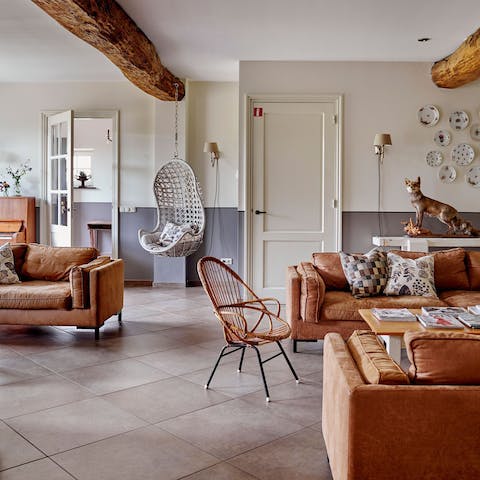 Spread out across leather sofas and the hanging egg chair in the lounge