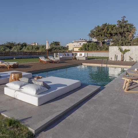 Relax on the day beds beside the private pool
