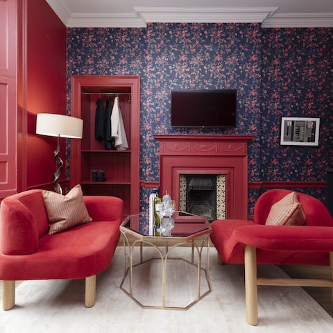 Enjoy a wee dram in the berry-hued living space