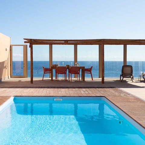 Spend days lounging poolside, with views overlooking the sea