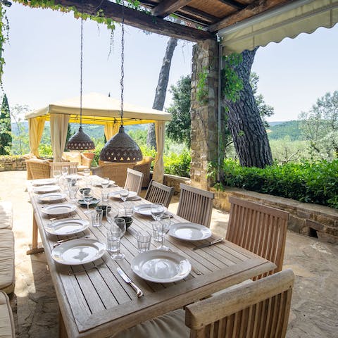 Dine with a view of the Chianti hills under the vine-dappled pergola