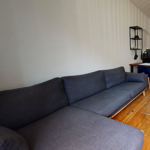 Stretch out in the living area after a day of discovering the city's cobbled streets