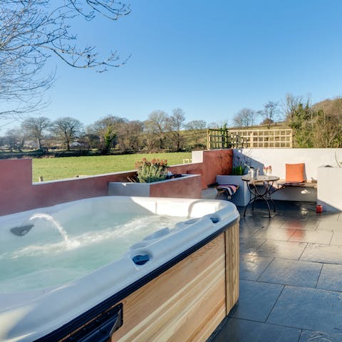 Relax in the bubbling hot tub after a day on your feet, taking in the wild scenery