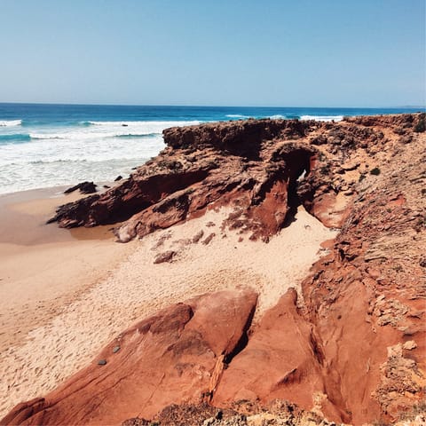 Head to the golden sands and red cliffs of Praia Galé-Fontainhas