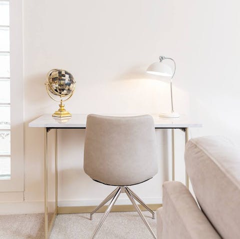 Catch up on work at the living room's chic desk space