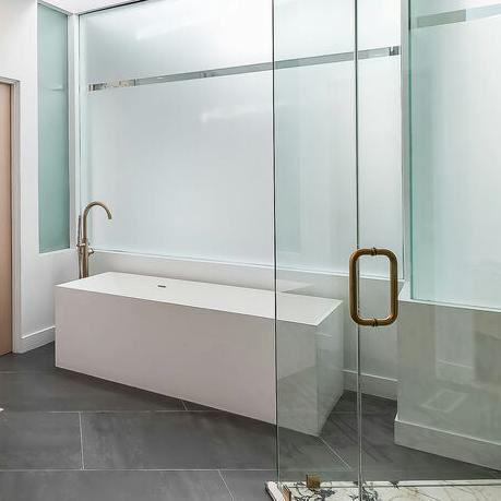 Enjoy a moment of indulgence with a luxurious bath in the sleek bathroom