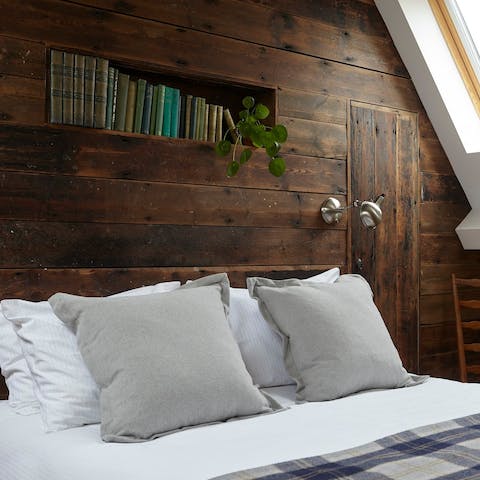 Cosy up in the rustic bedroom upstairs – we can't get enough of the timber panelling