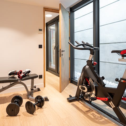 Workout in your private gym equipped with weights, exercise bike, rowing machine and yoga mat