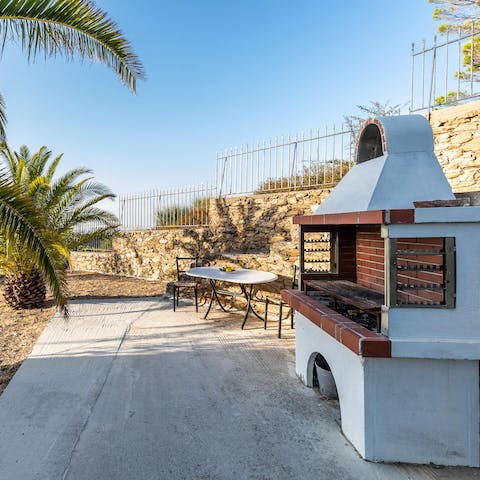 Treat guests to an alfresco banquet cooked up on the stone barbecue