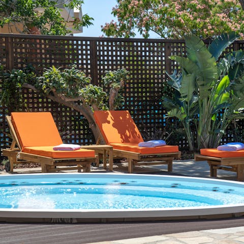 Enjoy a luxurious dip in the hot tub or sunbathe on a lounger