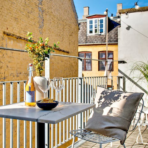 Peer out onto the historic buzzy streets below with pre-dinner drinks