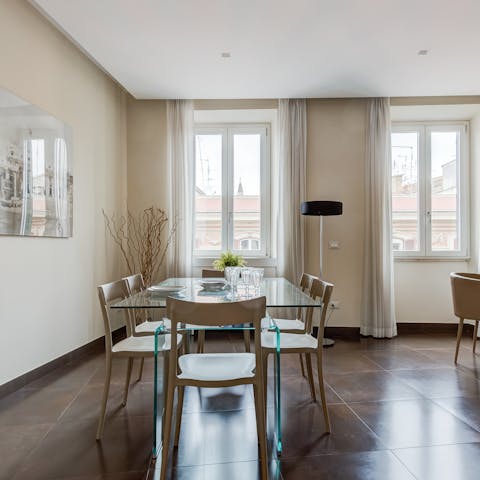 Enjoy a lazy brunch around the sleek glass-topped dining table