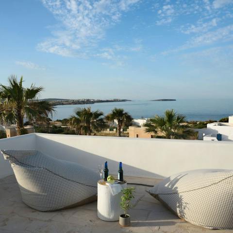 Sip on a glass of wine whilst overlooking the beauty of Paros