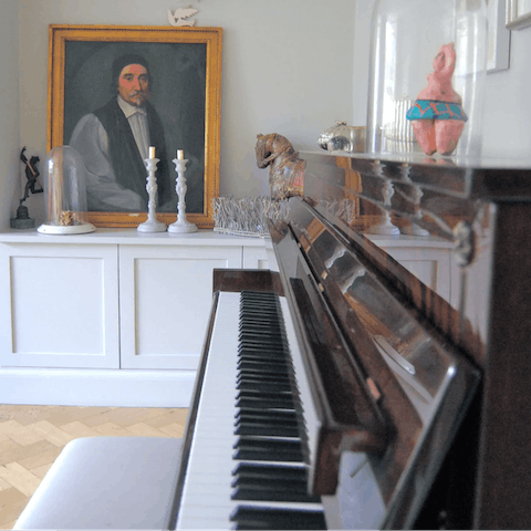 Tickle the ivories on the piano in the lounge